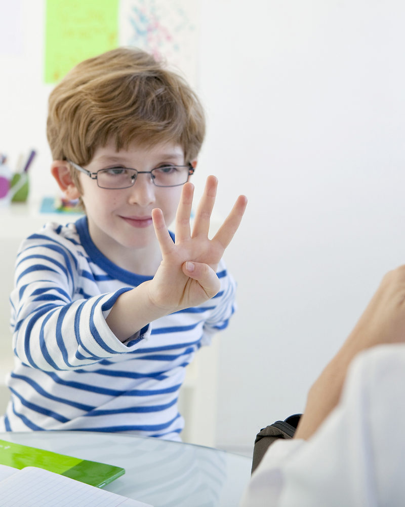 A boy holding up his hand